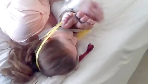 Two Women Tied Together Feet To Face